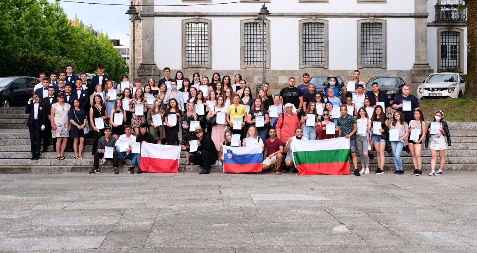 Participants with certificates and national flags in front of Braga town hall