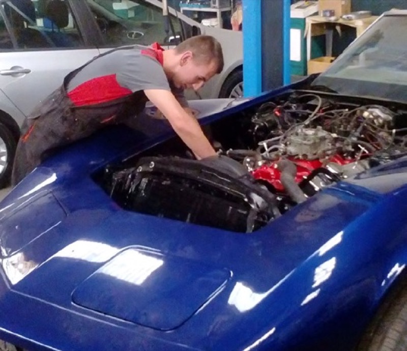 Car mechanics trainee in a workshop