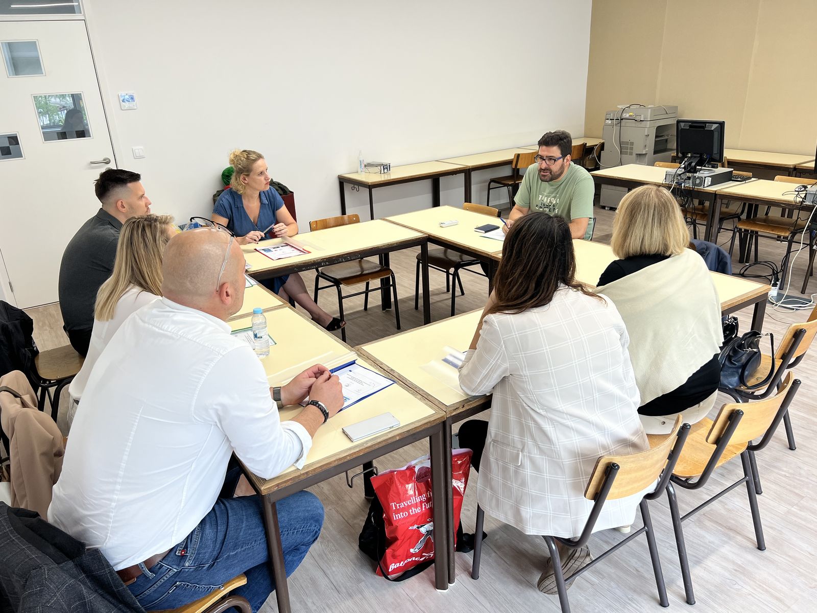 Coordinators and teachers at a meeting around a table