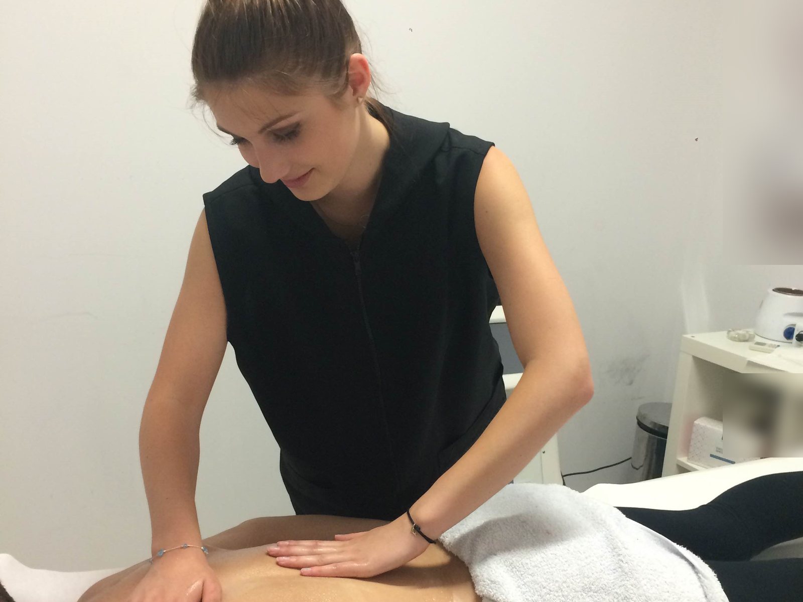 Beauty trainee giving a back massage