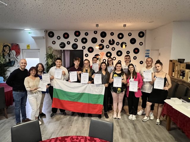 Group with the Bulgarian flag and their certificates