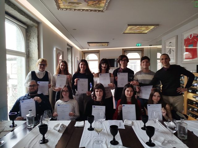 Group with their certificates at the table in a restaurant