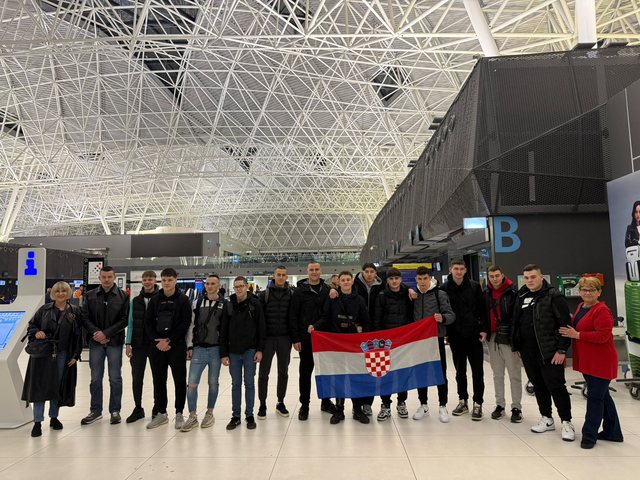 Group with the Croatian flag at the airport