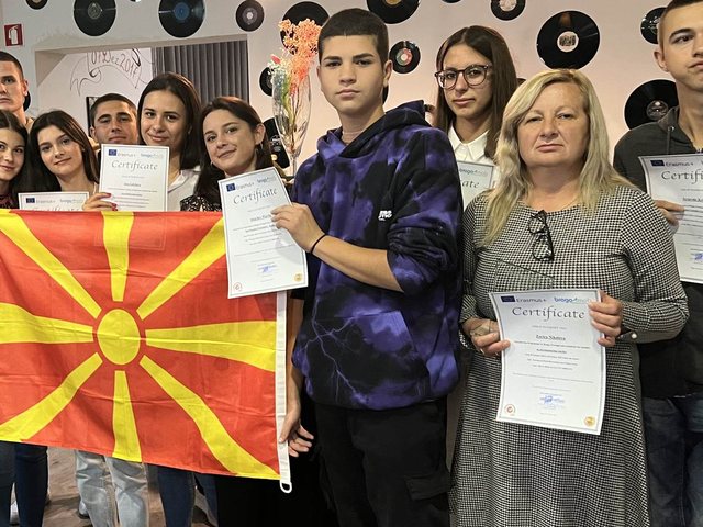 Group with the flag of North Macedonia and their certificates
